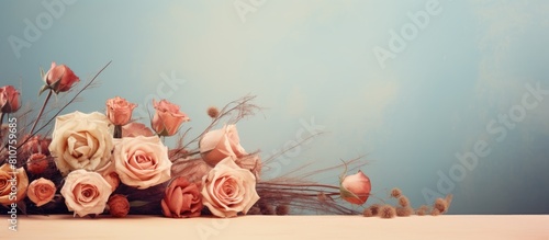 A vintage retro background with a bouquet of dried roses and flowers presenting a delicate perspective of numerous dried rose blossoms and an ample amount of copy space for composing