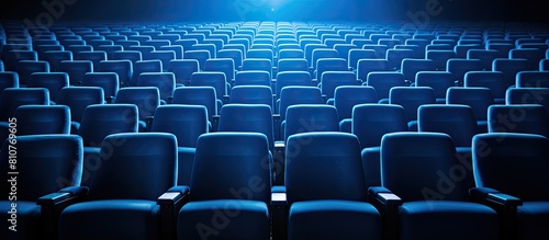 Rows of blue seats in a cinema hall providing seating for spectators Copy space image