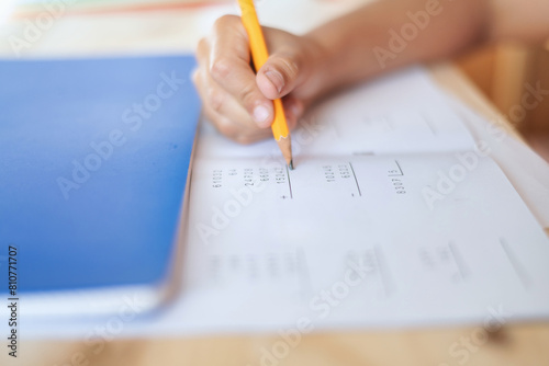 Close-Up Of A 9 Year Old Boy Using A Pencil Doing Math Exercises. Childhood Education.