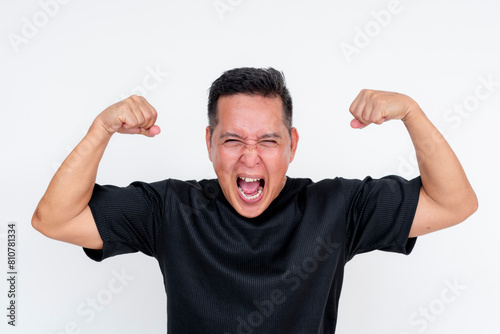 Middle-aged Asian man flexing biceps with pride, isolated on white background