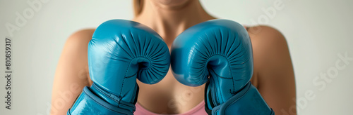 Woman in blue boxing gloves, concept of fighting for women's rights.