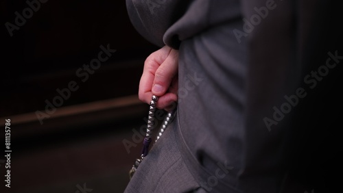 Catholic Nun Wearing Grey Religious Habit Tunic Saying Prayer on Holy Rosary