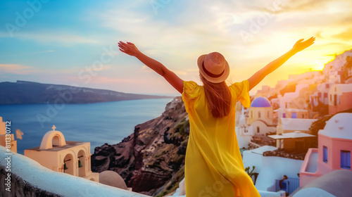 Europe travel vacation fun summer woman feeling free dancing with arms open in freedom at Oia, Santorini, Greece island,Embracing the Grecian Sunset: A Figure in Yellow Basks in the Warm Glow Overlook