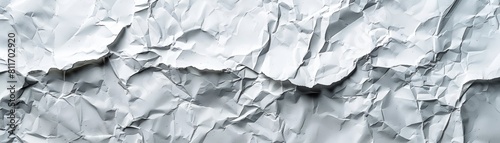 The image shows a close-up of a crumpled piece of white paper. The paper is textured and has a rough surface. The image is well-lit and the colors are bright and vibrant.