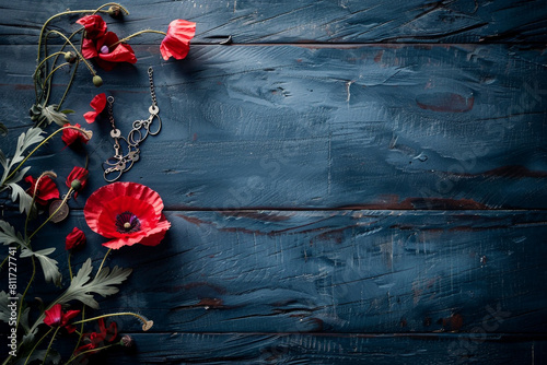 Dramatic dark blue wood with a red poppy and military tags, setting a somber ne Memorial Day.