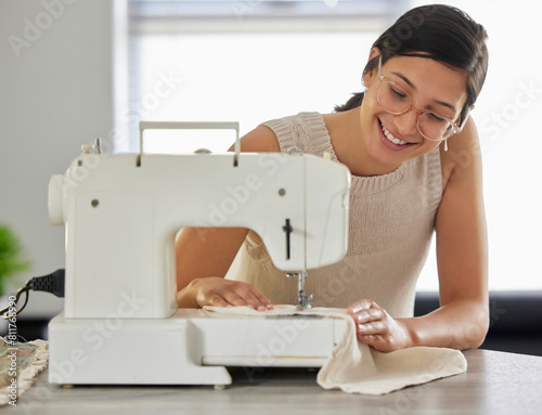 Happy, woman and sewing machine in apartment for small business, fashion design and pride. Female seamstress, smile and fabric in home workshop for production, clothing and start up career in textile