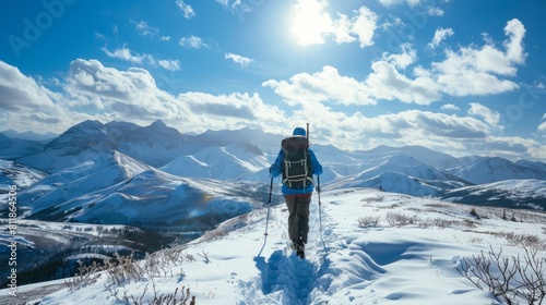 A person hikes up a snowy mountain trail