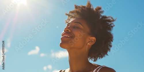 African American Woman Smiling Blissfully Against Sunny Sky, Joy and Happiness