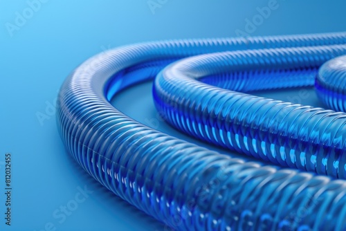 Close up of a blue hose on a blue surface. Suitable for industrial and plumbing concepts