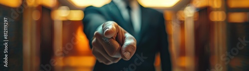 Close-up of businessman pointing finger at camera.