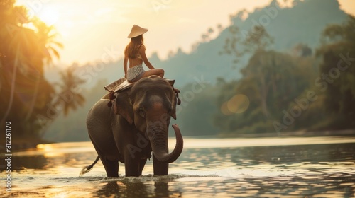 Young women riding an elephant in the natural scenery.