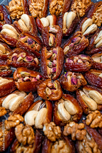 Gourmet Stuffed Dates with Pistachios and Almonds Close-Up, Close-up view of gourmet dates stuffed with almonds and pistachios, arranged beautifully. Perfect for Ramadan or dessert ideas.