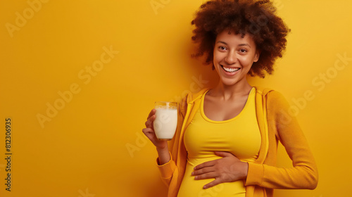a pregnant latin female holding a glass of milk