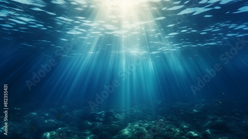 Underwater deep blue sea with rays of sun oceam bottom background