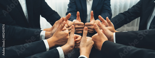 Office worker team stacking hand together symbolize successful group of business partnership and strong collective unity teamwork in community workplace in panoramic banner. Shrewd
