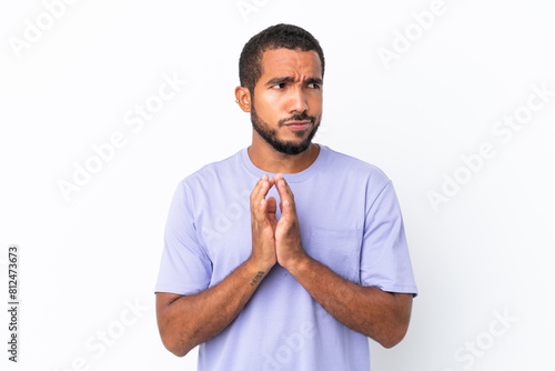 Young Ecuadorian man isolated on white background scheming something