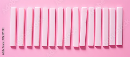 A flat lay of delicious chewing gum sticks arranged on a pink backdrop providing ample space for accompanying text