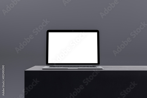 Stylish laptop with a blank screen on a minimalist podium, tailored for digital marketing and business presentations. 3D Render