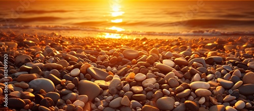 The beach is beautifully illuminated by the setting sun highlighting the coarse sand and small pebbles. Creative banner. Copyspace image