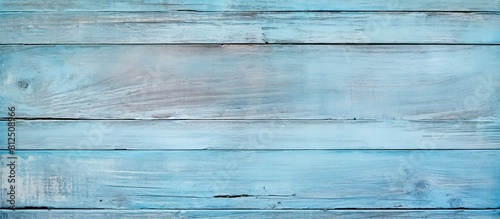 A vintage teak surface board or grunge plywood with a natural old antique pattern creating a pastel blue wooden wall texture background for design artwork or a floor Ample copy space image is availab