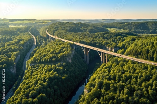 Generative AI. Luxembourg landscape. Majestic Aerial View of Highway Bridge Over Forested Valley at Sunset.