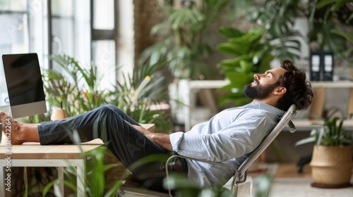 The image shows a man relaxing in a comfortable chair in a green office