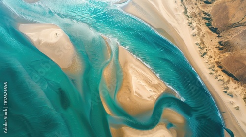 Blurry aerial view of a desert river sand and sea