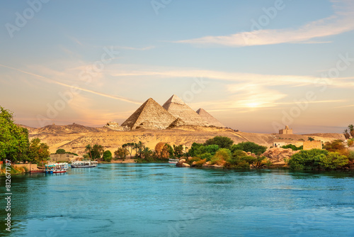 View on the Nile and the boats at sunset in the Aswan desert near the Pypamids of Egypt