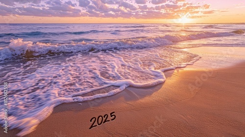 New year '2025' scribed on beach, waves about to cleanse. 2025 countdown