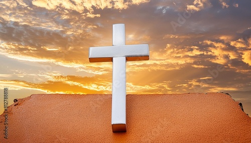white shining christian cross on the orange cloudy sky background