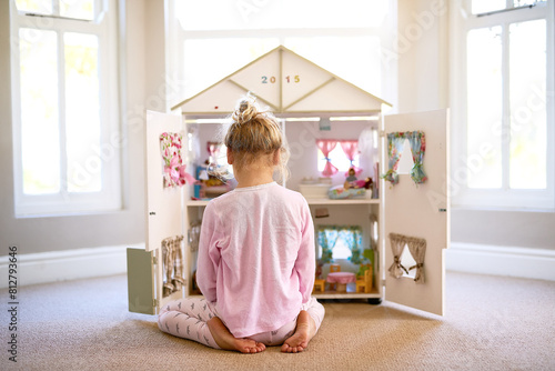 Girl, dollhouse and home for playing, toys and fun in adorable, child and miniature. Creative, games and pretend for learning, development and young with mini furniture, enjoy and rear view or kid