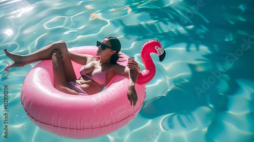 Relaxing woman floating in flamingo inflatable swimming pool toy at luxury resort using mobile phone sunbathing Caribbean travel vacation hotel lifestyle : Generative AI