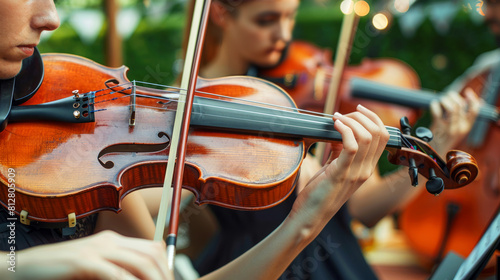 Elegant outdoor string quartet performance with violinists intensely playing at a garden event