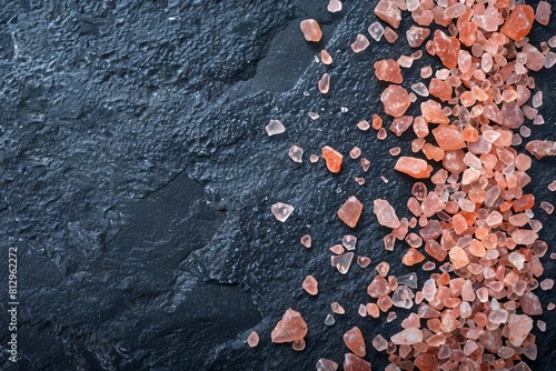 pink himalayan salt crystals scattered on a dark contrasting surface capturing their raw natural beauty food photography
