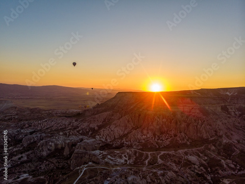 Aerial view of hot air balloons at dawn against the light, flying over the valleys of Cappadocia, 07-08-2019. Turkey