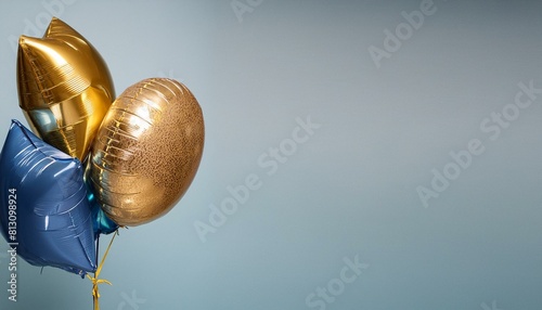 Blue and gold flying balloon on light blue background 