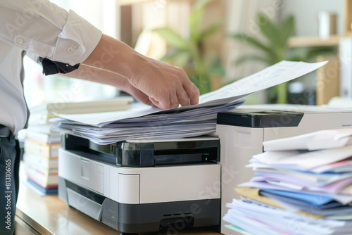 A person is using a printer to print out papers