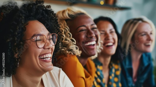 diverse group of women laughing in modern office inclusive stock photo