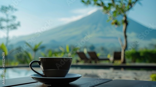 Close up a cup of black coffee and Slamet montain on the background