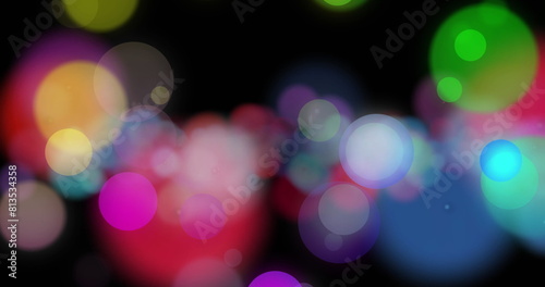 Image of flashing multi coloured lights on black background