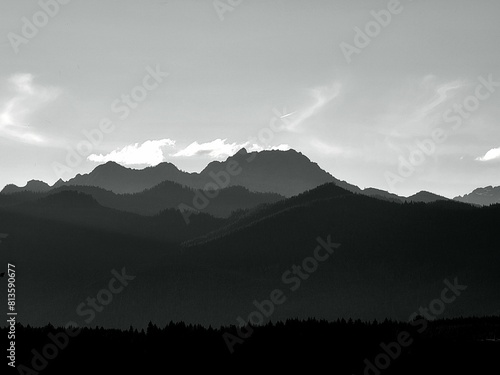 Low-angle grayscale of the Olympic mountain range seen from the Kitsap peninsula