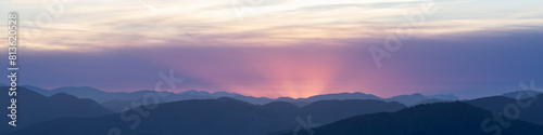 Banner 4x1 Linkedin Sunset landscape in the mountains. Red sun rays over the mountains in the Austrian Alps