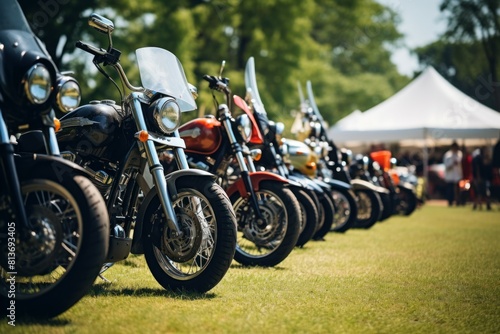 Lineup of various motorcycles on display at an outdoor event with a blurred background