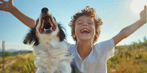 A heartwarming moment of a young boy with his arms raised joyfully alongside his exuberant dog in a sunny field