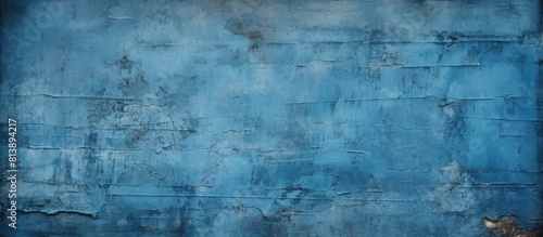 A grungy background or texture featuring a blue scraped wall with plenty of copy space image