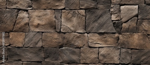 Copy space image of a closeup rough basalt texture on an old medieval stone road creating a brown natural backdrop with intricate patterns from the stone fragments of the historical floor covering