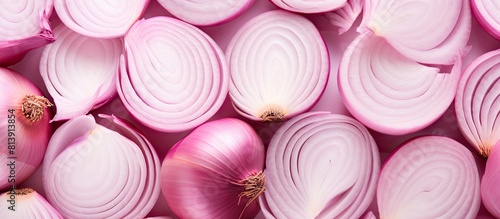 The image showcases a beautiful arrangement of sliced pink onions forming an isolated pattern within a frame The copy space makes it the perfect food background