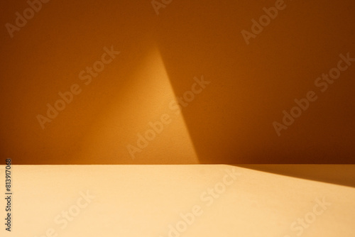Empty table with light reflection on dark brown wall. Mock up for branding products, presentation, food and health care..
