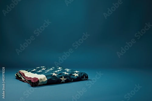 A patriotic image of a folded American flag on a blue background. Perfect for memorial day or 4th of July designs