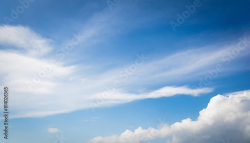 Blue sky background with white clouds. Cumulus and stratus white clouds in the blue sky.